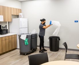 5 Star Janitorial employee changes a trash bag
