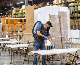 5 Star Janitorial employee cleans the floor in a warehouse